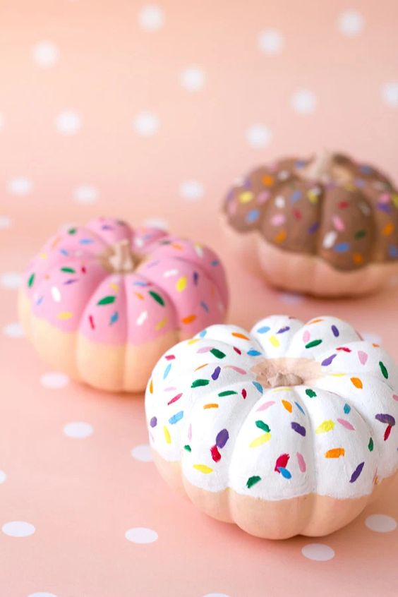 pretty pumpkins turned into donuts with glazed and confetti are amazing for Halloween decor