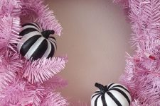 08 a gorgeous faux evergreen Halloween wreath with black and white stipred pumpkins is a perfect idea for your front door