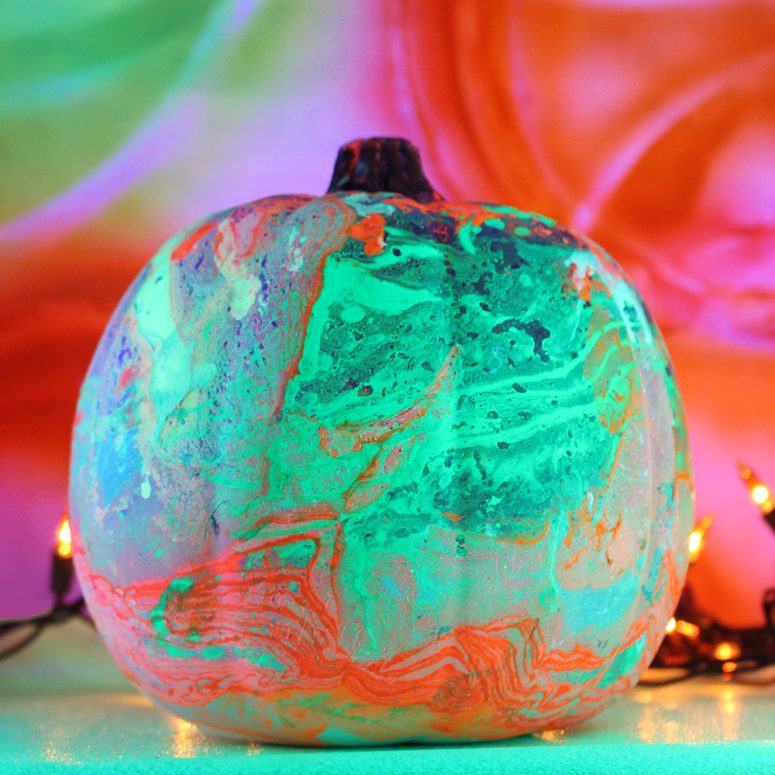 a green, orange and pink marbleized pumpkin is a gorgeous decoration for Halloween that doesn't require any carving