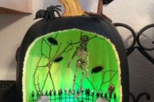 09 a scary green Halloween diorama with skeletons, skulls, blackbirds, branches and moss is a gorgeous decor idea