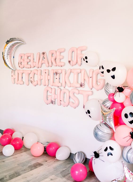 gorgeous pink Halloween styling with lots of balloons   pink, silver and scary ghost ones, pink balloon letters and a silver moon