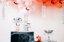 10 gorgeous Halloween decor with pink and orange balloons and bats, with storage furniture covered with spiderweb, bats and disco balls