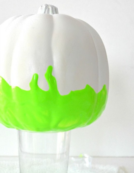a white pumpkin with neon green touches is a gorgeous idea for modern and bold Halloween decor or just for the fall