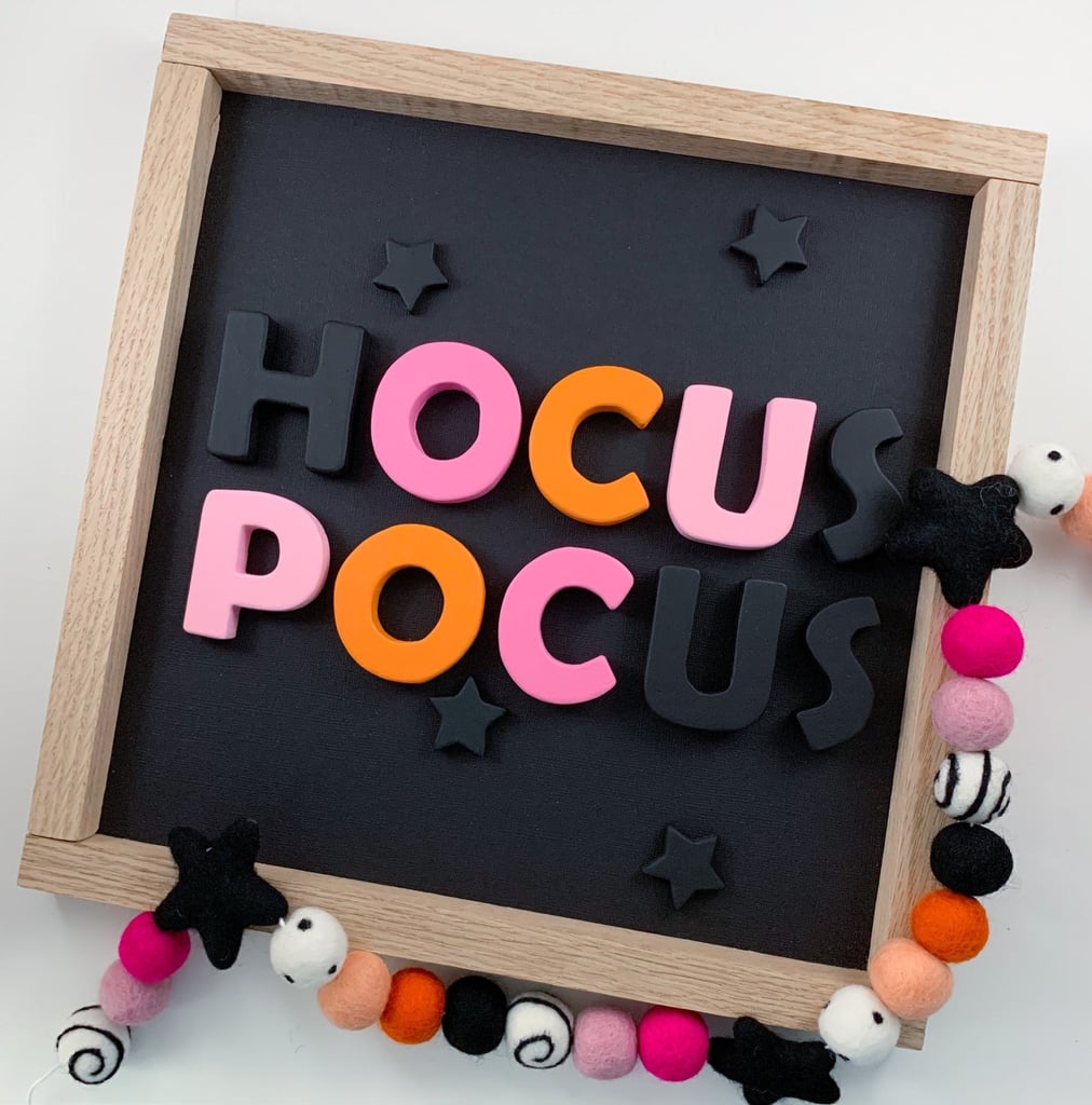 a Hocus Pocus Halloween wall decoration with colorful letters including pink ones is a fun idea for both a kid and an adult party