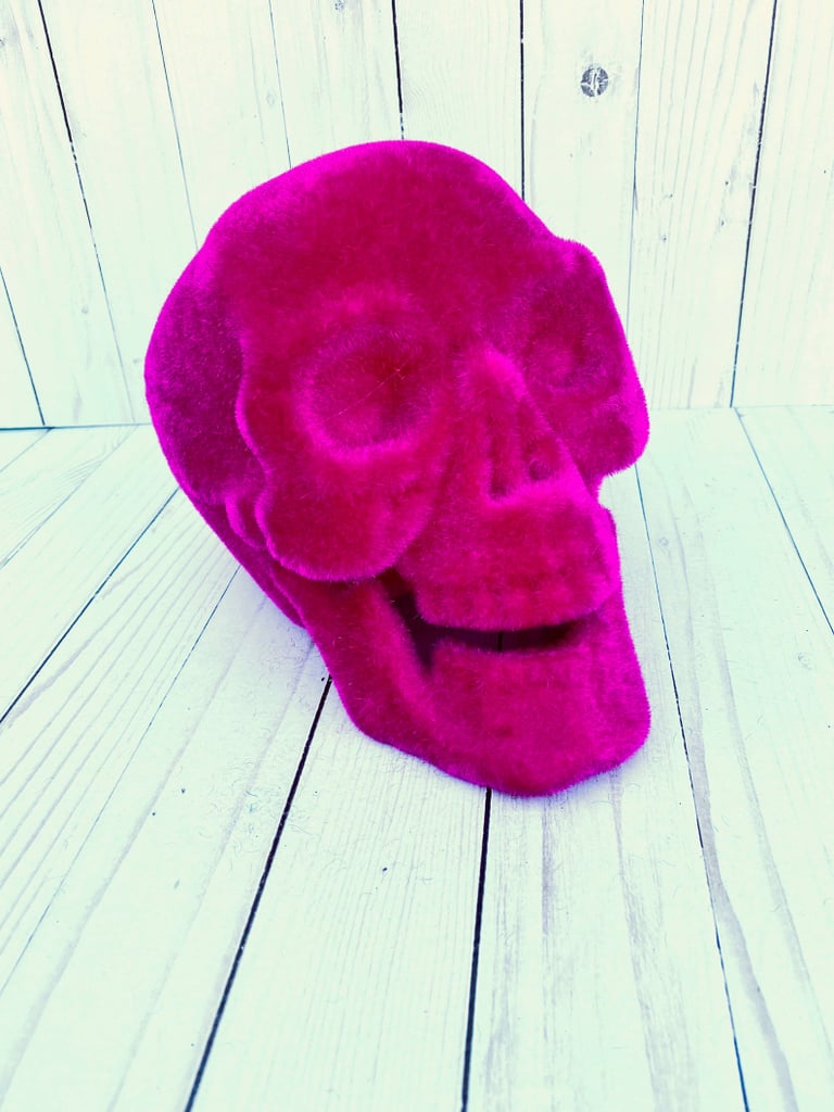 a hot pink velvet skull is a very cool solution for Halloween, a fresh take on traditional decor