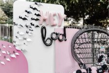 19 a pink, black and white Halloween party setting with paper bats, balloon letters and a black lace spiderweb runner