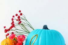 20 a bold blue pumpkin decorated with gold sequins that form a word is a cool and bright idea for Halloween