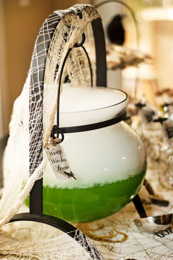 a creepy witch's cauldron in bold green with a tag is a cool and easy decoration for Halloween