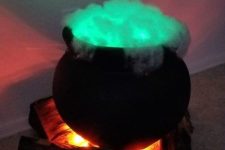 a glowing witch cauldron with green smoke inside and some firewood is always a cool idea for Halloween styling