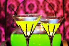 23 neon green Halloween drinks in glasses holded by skeleton hands – yes, please