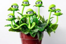 25 a man-eating plant in neon greens put in a usual planter is a creative and fun decoration for Halloween