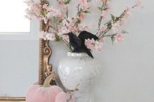 25 glam Halloween decor with faux pink blooms and pink velvet pumpkins plus a black lace spiderweb on the mantel is all cool
