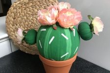 28 a pumpkin turned into a fun and colorful cactus, topped with paper blooms is a gorgeous idea for Halloween