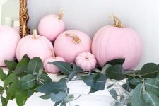 28 pink pumpkins with gold stems and greenery on the mantel for a lovely and glam Halloween mantel is amazing