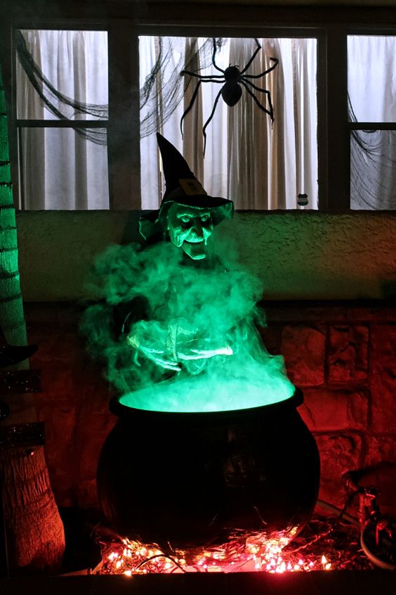 a witch at a cauldron with green smoke will be a nice and scary decoration for Halloween and is a great idea