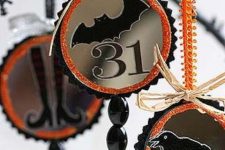 Halloween ornaments with black beads and crystals, with bats, blackbirds and witch’s legs, with ribbons and orange touches