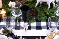 a beautiful woodland Thanksgiving tablescape will fit both Thanksgiving and Christmas, with its plaid linens, pinecones and fern