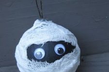 a black mummy Halloween ornament with googly eyes is a lovely idea for this holiday and looks fun and cool