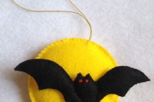 a bold Halloween ornament of felt showing a yellow moon and a bat is classics for this holiday and you can DIY it
