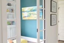 a bright space separated with glass French pocket doors from the rest of the space lets the light inside the entryway, too