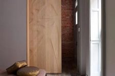 a gorgeous wooden pocket door with a pattern is a beautiful decor feature that separates the space in a cool way