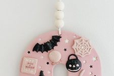 a lovely pink and black polymer clay Halloween ornament with bats, spiders, stars, hats and much more is the cutest