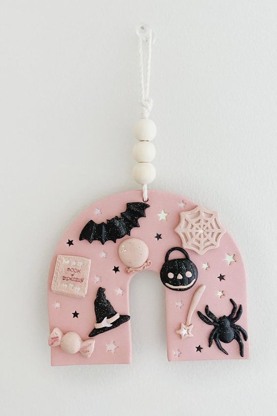 a lovely pink and black polymer clay Halloween ornament with bats, spiders, stars, hats and much more is the cutest