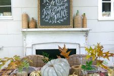 a modern farmhouse Thanksgiving tablescape with mismatching plaid tablecloths and napkins, natural pumpkins and fall leaves