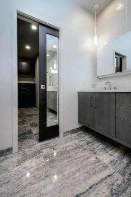 a modern farmhouse space with a mirror pocket door in a dark stained frame is a cool idea, you won't need another mirror