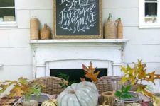 a rustic Thanksgiving tablescape with a plaid tablecloth, patterned chargers and black plates, neutral natural pumpkins and fall leaves