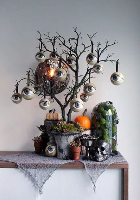 a scary Halloween tree with eyeball ornaments is a bold and statement like idea to style your space for this spooky holiday