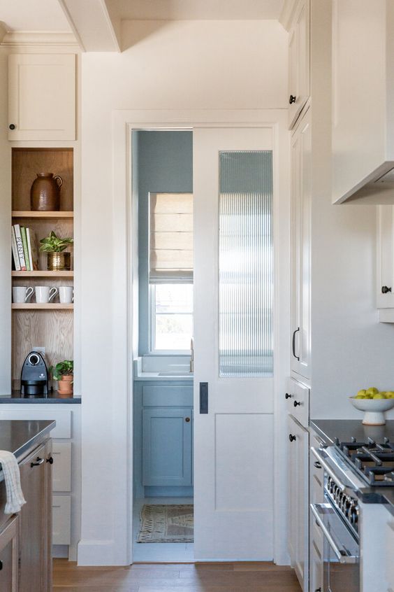 a white frosted glass pocket door like this one won't take any space and will delicately separate rooms in your home
