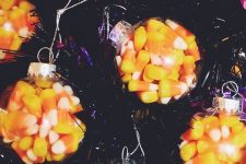 clear ornaments filled with candy corn are perfect for Halloween and can be rocked for fall and Thanksgiving decor