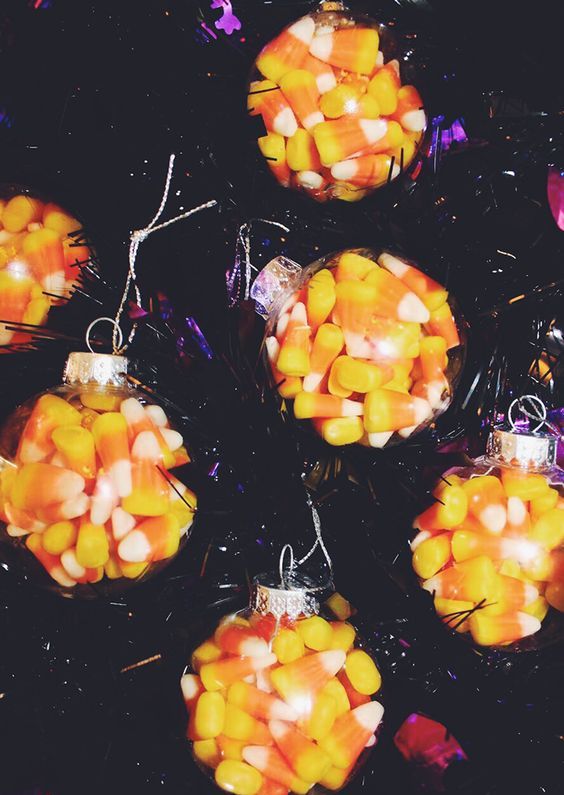clear ornaments filled with candy corn are perfect for Halloween and can be rocked for fall and Thanksgiving decor