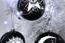 elegant and catchy Halloween ornaments in black and white, with painted images are amazing for styling your space for this holiday