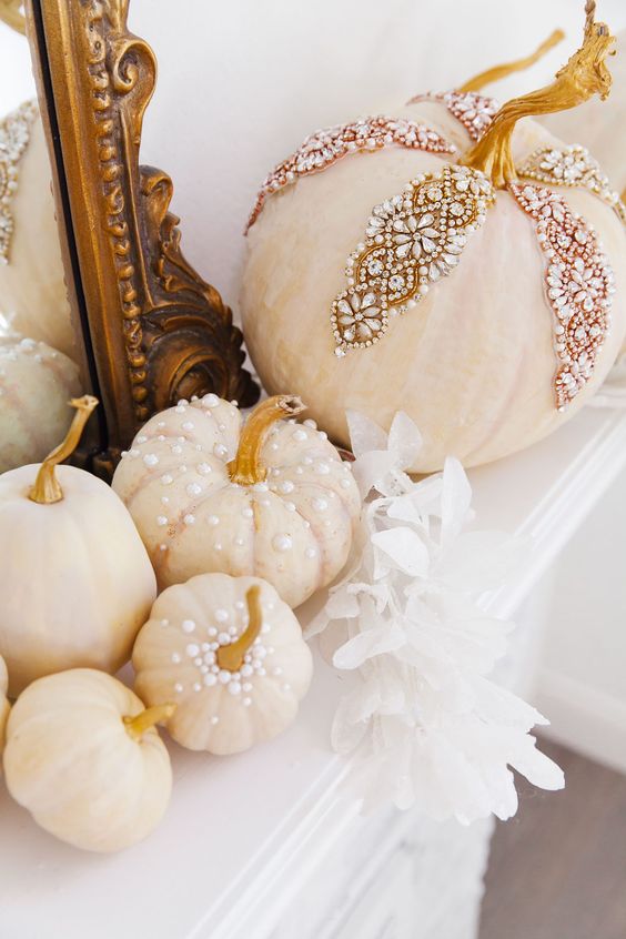 gorgeous glam Thanksgiving or fall decor of pumpkins decorated with pearls and rhinestones is a fantastic idea for a touch of chic