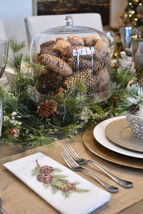 such a woodland tablescape with evergreens and pinecones will do not only for a woodland Thanksgiving table but also for a Christmas one