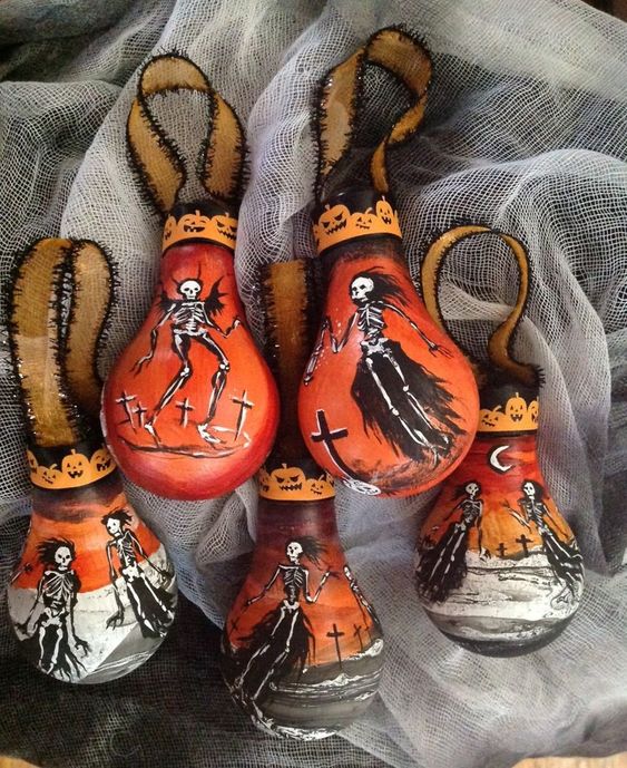 turn old and non working bulbs into really stunning Halloween ornaments painting them with various skeletons