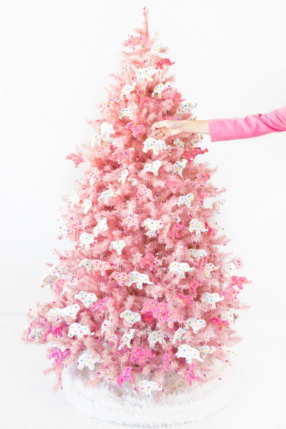 a blush Christmas tree decorated with pink and white circus animal cookie ornaments is a creative solution with color and unique ornaments