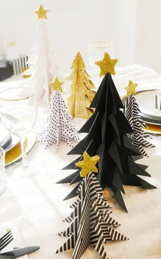 a black and white Christmas trees and gold ones with various patterns and gold glitter star toppers for holiday decor