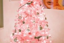04 a pastel pink Christmas tree with white and metallic ornaments and quirky birdie ornaments plus lights