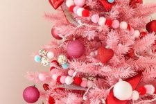 05 a pink Christmas tree decorated with pink and white ornaments, red hearts, pompoms is a very cool and out of the box idea to rock