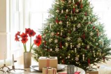 05 a traditional Scandi Christmas tree with gorgeous white snowflakes and red ornaments plus lights is a gorgeous holiday decoration and a bold statement in the space