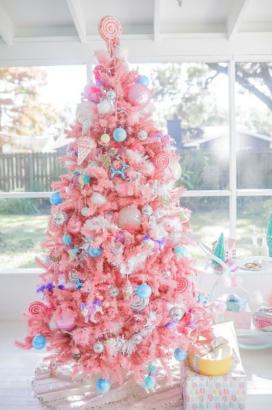 a bright candy colored Christmas tree with bold blue ornaments, ice cream and popsicle ornaments and a candy topper