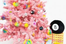 08 a bright pink Christmas tree with funny and colorful modern ornaments including emoji ones ooks fresh and very bold