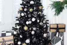 08 a classy Christmas tree in black with white, black and gold ornaments and stars and lights is all glam and chic