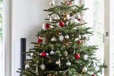 09 a traditional Christmas tree with white, red, metallic ornaments, balls, snowflakes and stars looks bold, catchy and screams holidays