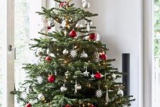 13 a bright Christmas tree in Scandi style, with white, silver and red ornaments plus a bear tree topper is cool