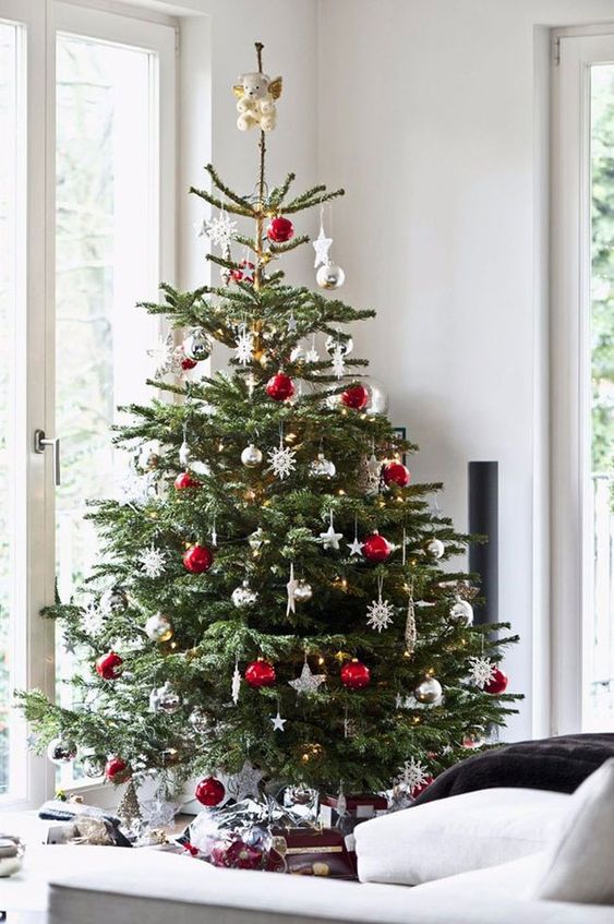 a bright Christmas tree in Scandi style, with white, silver and red ornaments plus a bear tree topper is cool