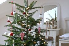 14 a classic Nordic Christmas tree decorated with red and white ornaments and felt hearts plus some lights is a very cute idea
